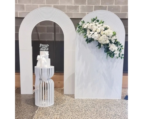 white ripple backdrop and arch with curved hourglass plinth for hire in Melbourne